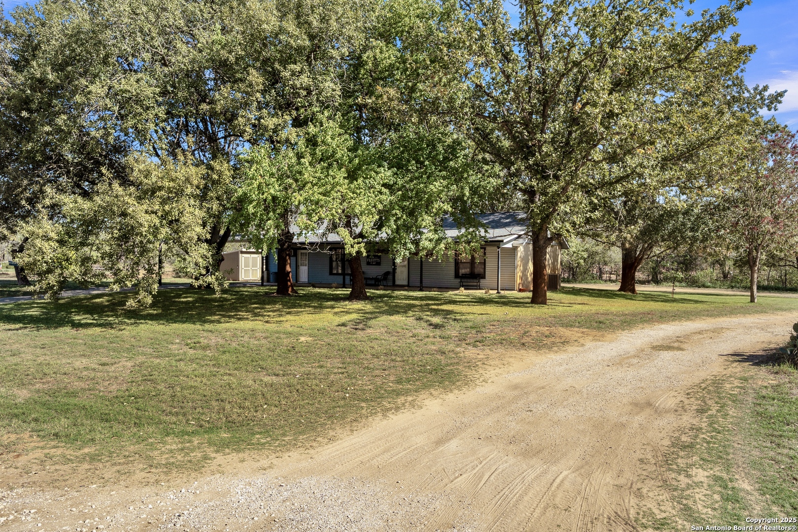 470 Rutledge Road Poteet, TX 78065 - Photo 6 of 40 a house with trees in the background