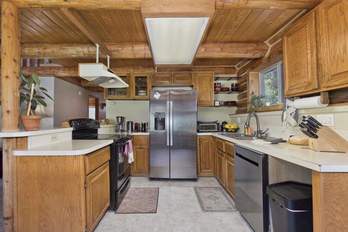 64 Carson Street June Lake, CA 93529 - Photo 13 of 47 a kitchen with stainless steel appliances granite countertop a sink a stove and a refrigerator