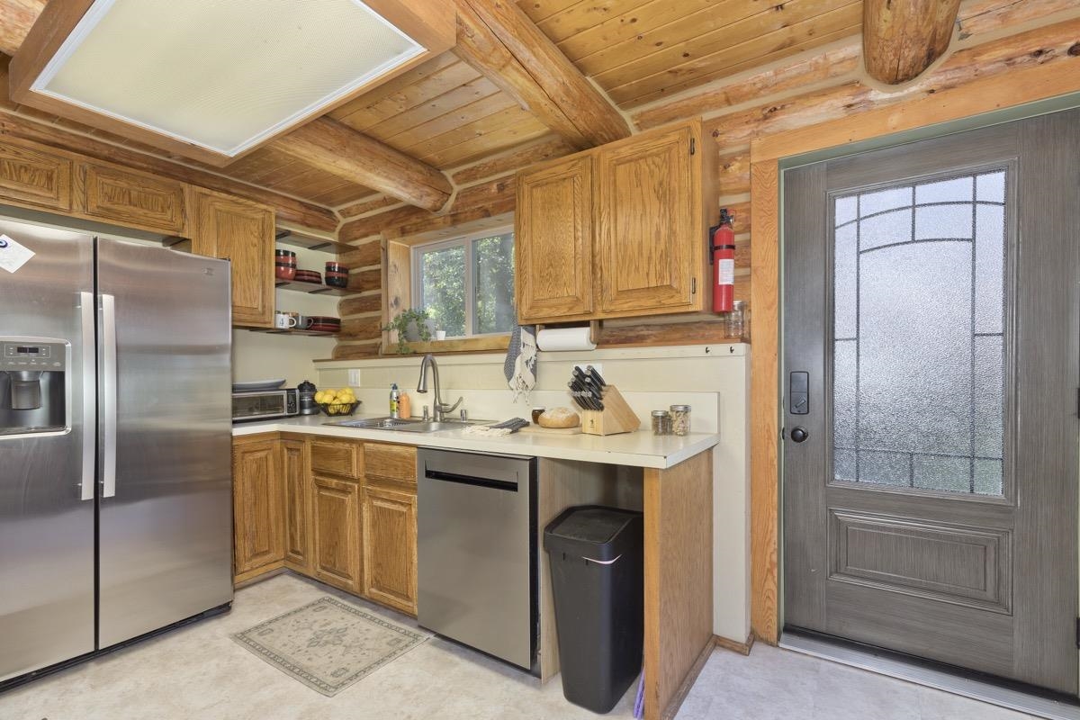 64 Carson Street June Lake, CA 93529 - Photo 14 of 47 a kitchen with stainless steel appliances a sink a refrigerator and cabinets