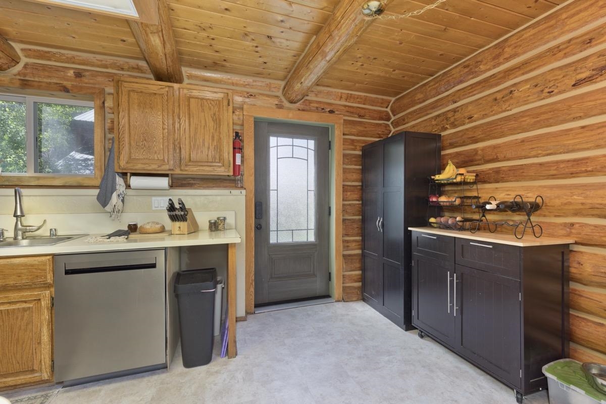 64 Carson Street June Lake, CA 93529 - Photo 15 of 47 a kitchen with kitchen island granite countertop a sink cabinets and stainless steel appliances