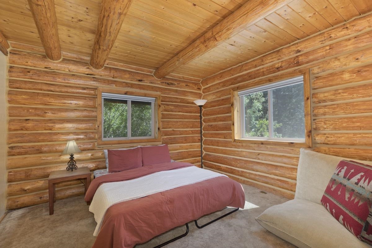 64 Carson Street June Lake, CA 93529 - Photo 19 of 47 a bedroom with a bed and wooden floor