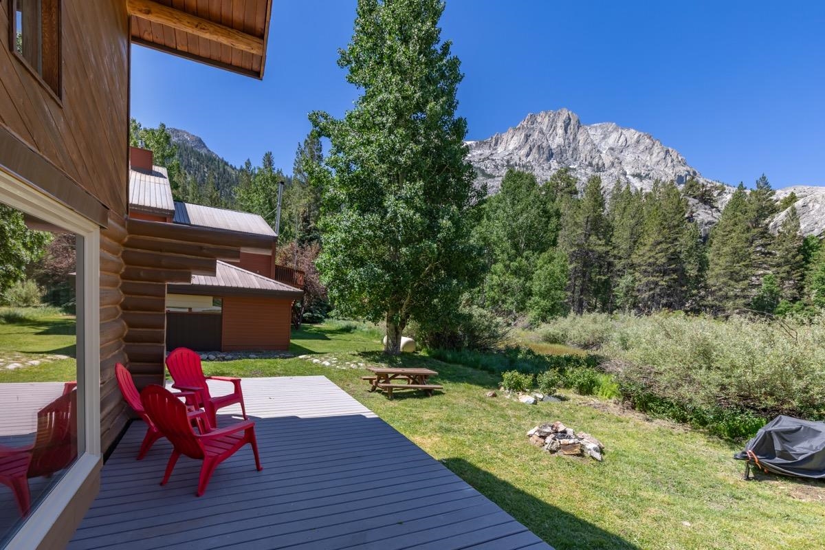 64 Carson Street June Lake, CA 93529 - Photo 2 of 47 a view of a chairs and table in patio with wooden floor