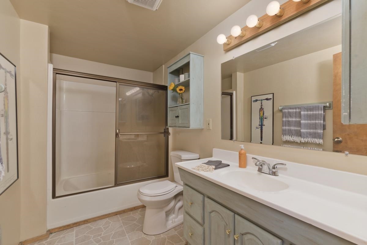64 Carson Street June Lake, CA 93529 - Photo 24 of 47 a bathroom with a granite countertop sink toilet and shower