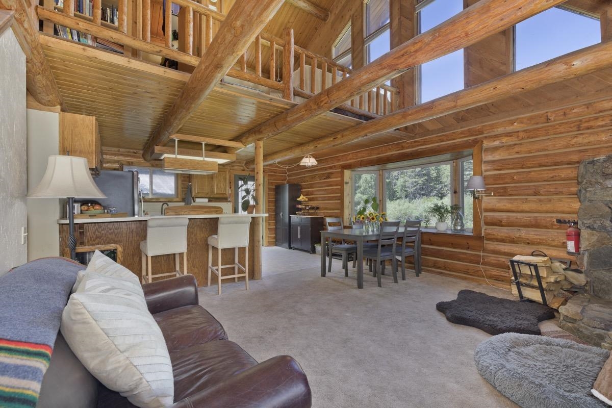 64 Carson Street June Lake, CA 93529 - Photo 5 of 47 a living room with furniture a fireplace and a large window