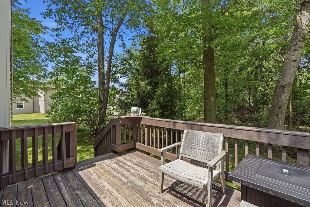 2323 Call Road Stow, OH 44224 - Photo 5 of 42 Wood deck with railing and stairs leading to a grassy area, surrounded by mature trees