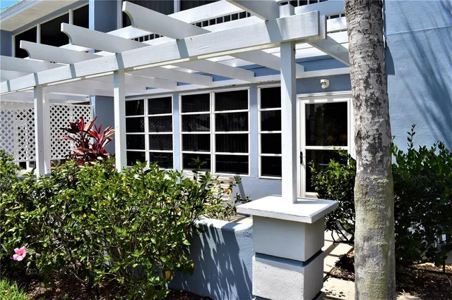 a view of a patio with table and chairs and potted plants