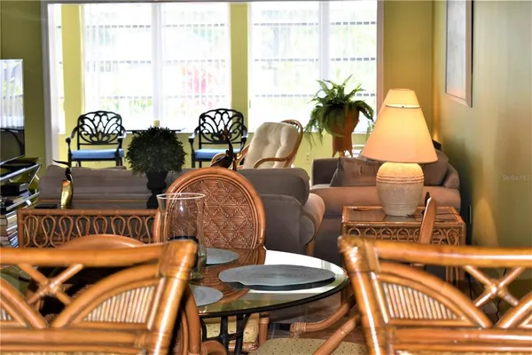 a living room with furniture and floor to ceiling windows