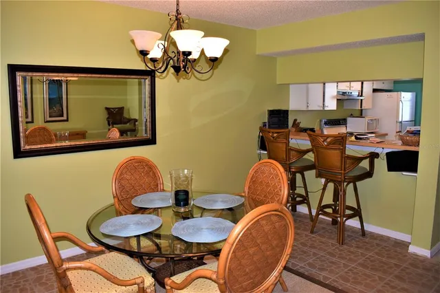 a dining room filled chandelier and wooden floor