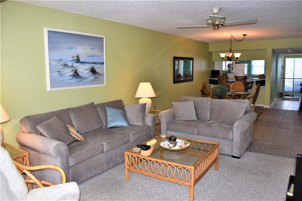 448 Cerromar Road, Unit 189 Venice, FL 34293 - Photo 21 of 48 a living room with furniture and a chandelier