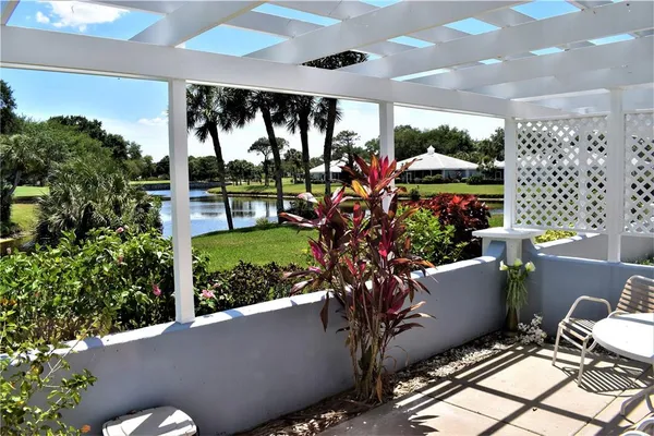 a view of a porch with furniture and garden