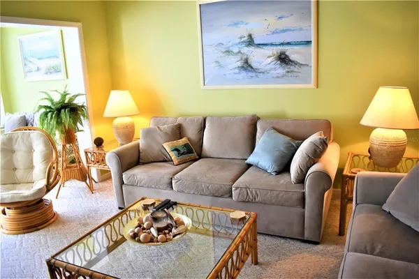 a living room with furniture and a potted plant