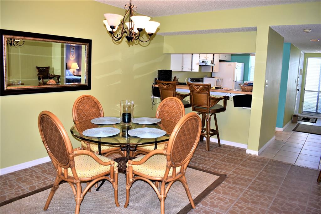 448 Cerromar Road, Unit 189 Venice, FL 34293 - Photo 38 of 48 a dining room filled chandelier and wooden floor