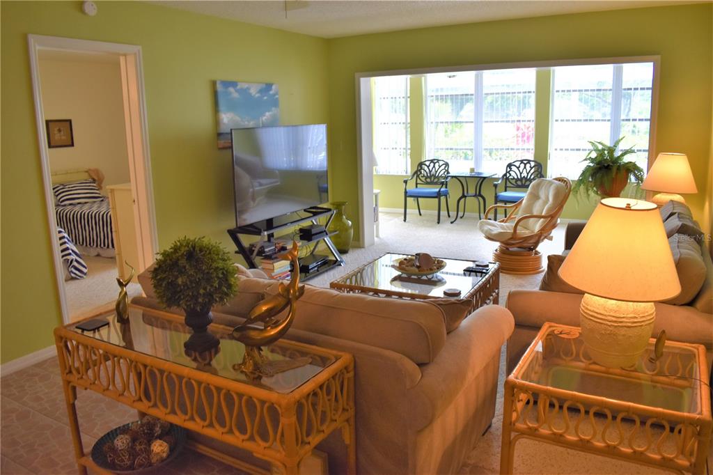 448 Cerromar Road, Unit 189 Venice, FL 34293 - Photo 7 of 48 a living room with furniture and a floor to ceiling window