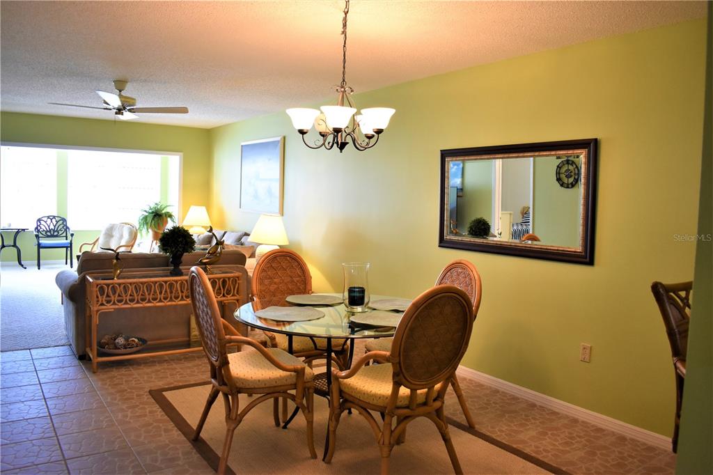 448 Cerromar Road, Unit 189 Venice, FL 34293 - Photo 8 of 48 a dining room with furniture and chandelier