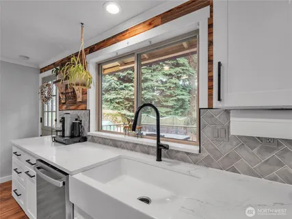 a kitchen with a sink and a large window