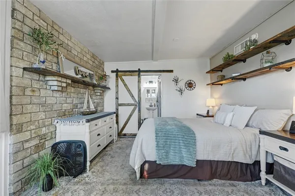 a kitchen with stainless steel appliances a table and chairs in it