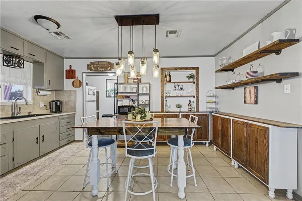 a kitchen with stainless steel appliances granite countertop a sink and a refrigerator