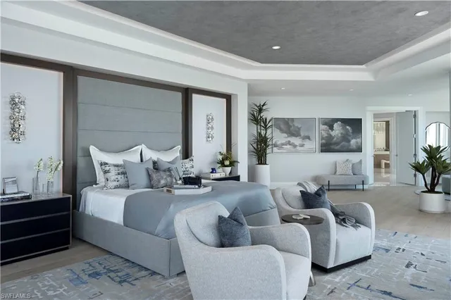 a bedroom with a bed and large window