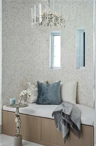 a living room with a bed and a painting on the wall