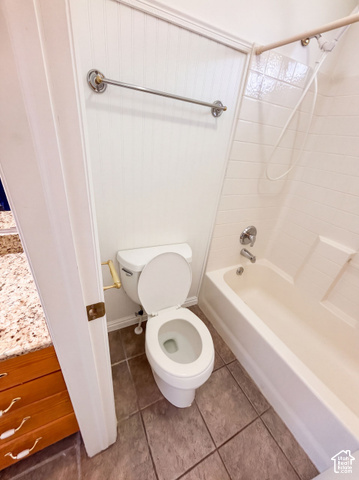 232 Bugle Way Providence, UT 84332 - Photo 19 of 36 White beadboard paneling, ceramic tile flooring, and a shower-over-tub combination
