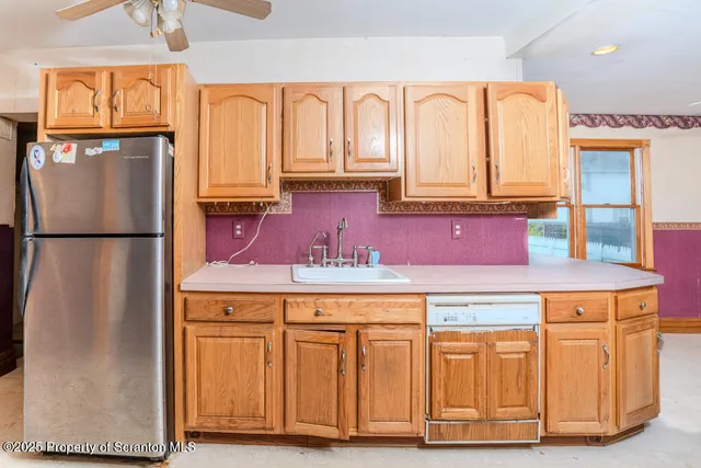 a bathroom with a granite countertop sink a mirror and a shower