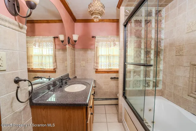 a bathroom with a granite countertop sink a mirror and a shower