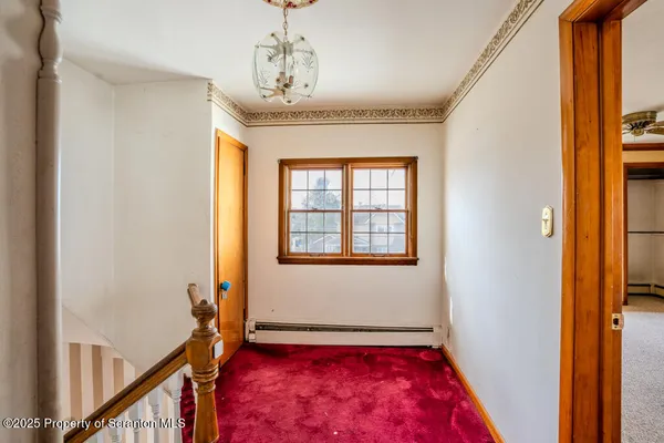 a view of entryway and hall with a door