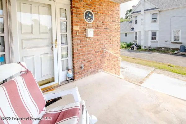 a view of a porch with chairs and a bench