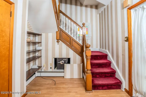 a view of entryway and hall with wooden floor