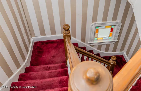 a view of staircase with a rug