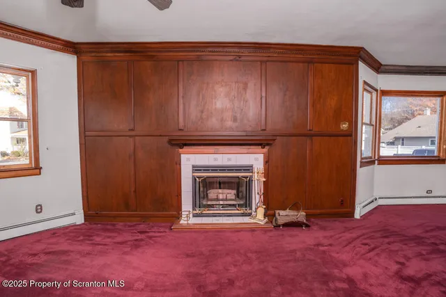 a view of empty room with furniture and a fireplace