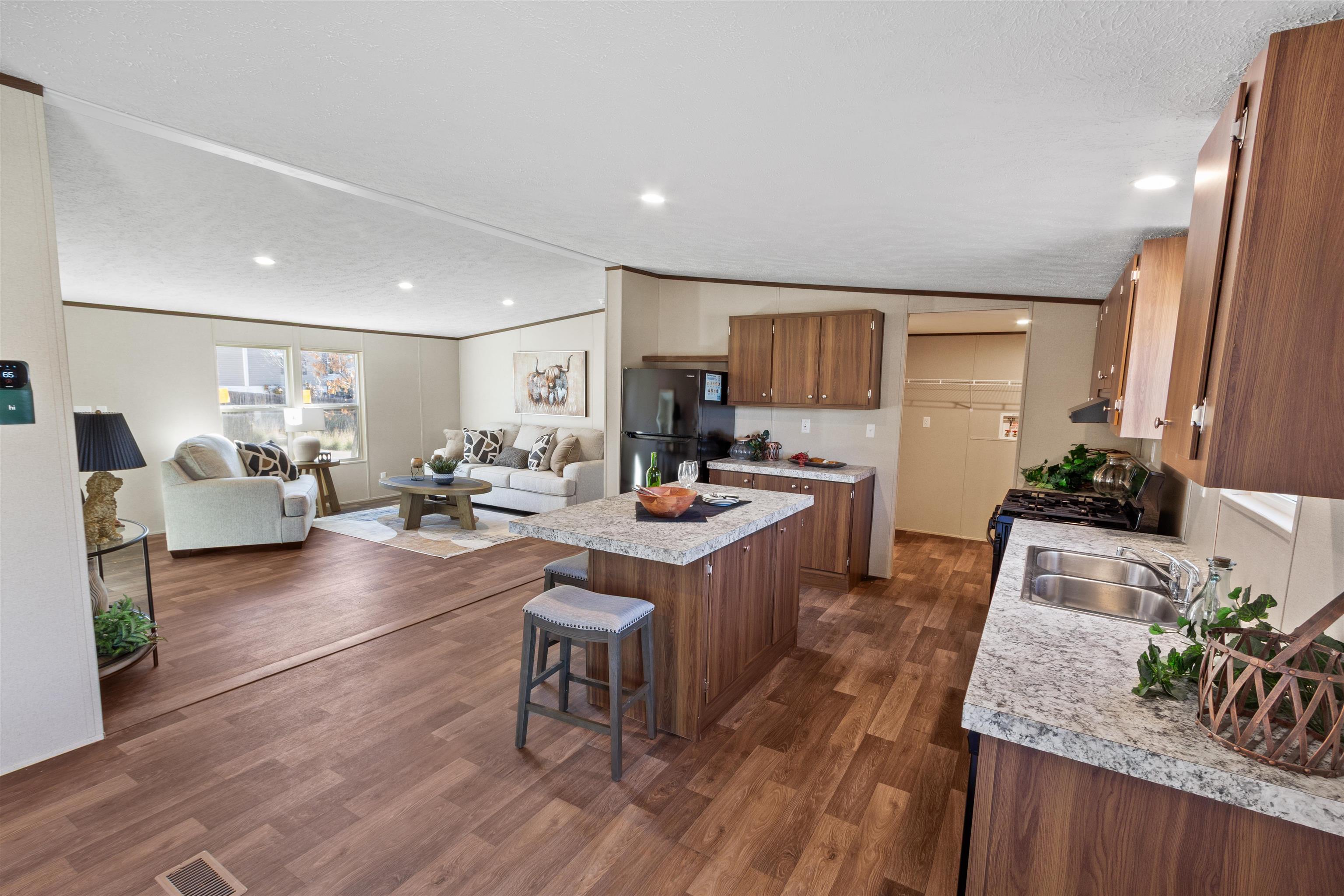 133 West Carson Circle Parachute, CO 81635 - Photo 11 of 25 a large living room with kitchen island granite countertop furniture a rug and a potted plant