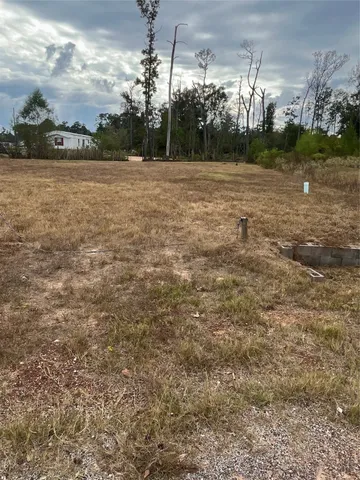 a view of a yard with wooden fence