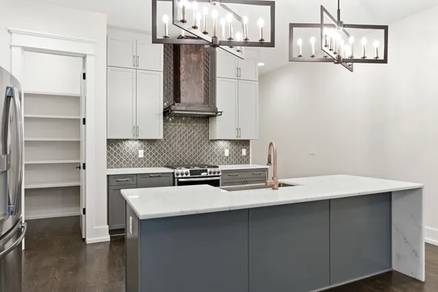 a kitchen with a sink cabinets and appliances