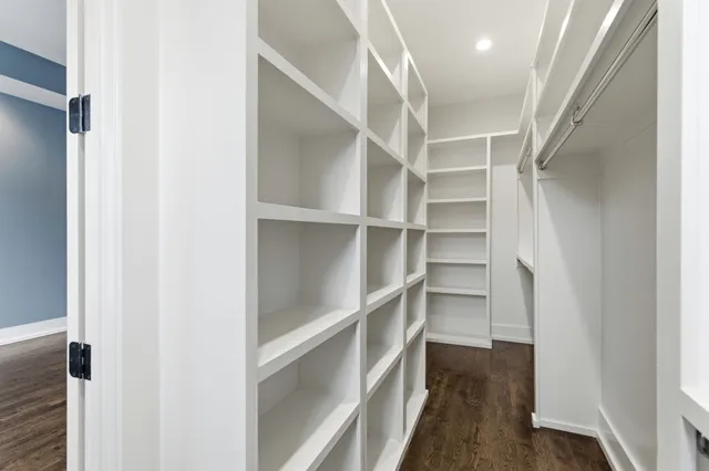 a view of walk in closet with empty racks