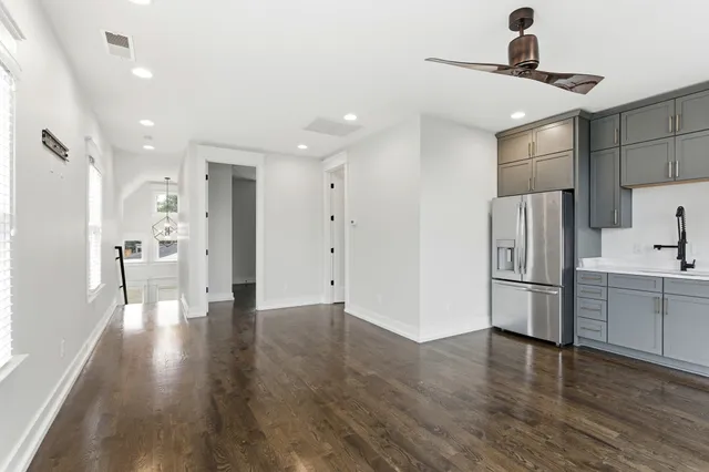 a view of a kitchen with a sink and stainless steel appliances