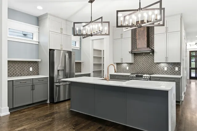 a kitchen with stainless steel appliances a sink stove and refrigerator
