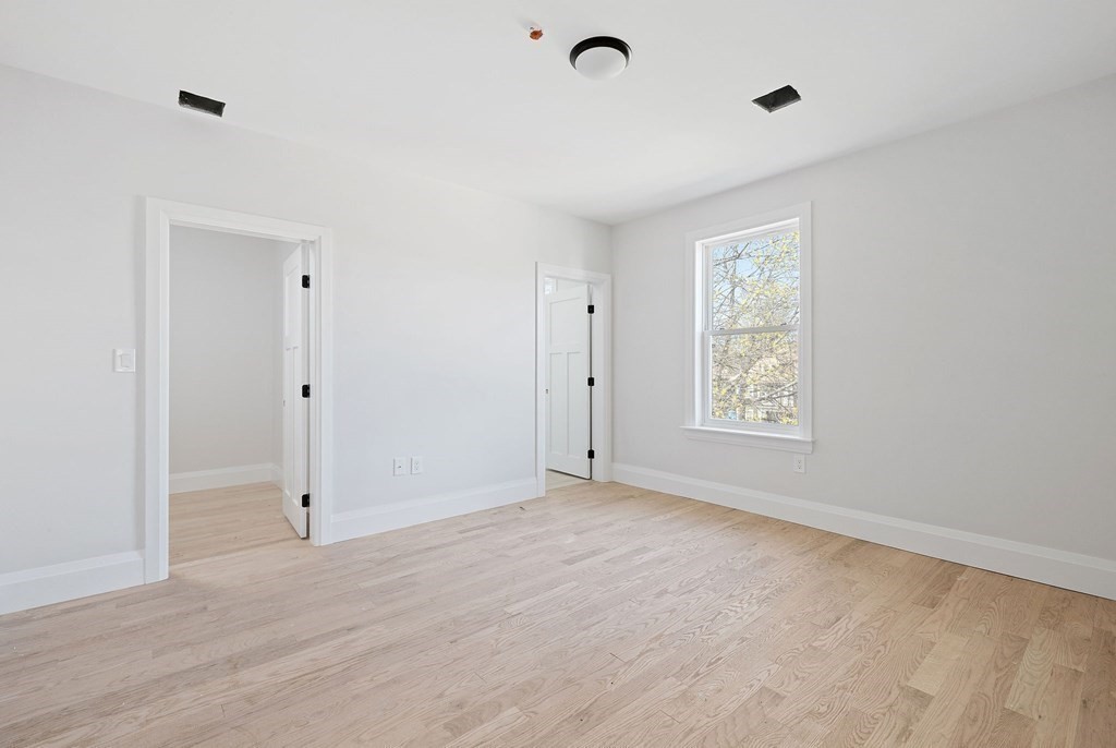 849 Cummins Highway, Unit 3 Boston, MA 02126 - Photo 3 of 7 a view of an empty room with a window