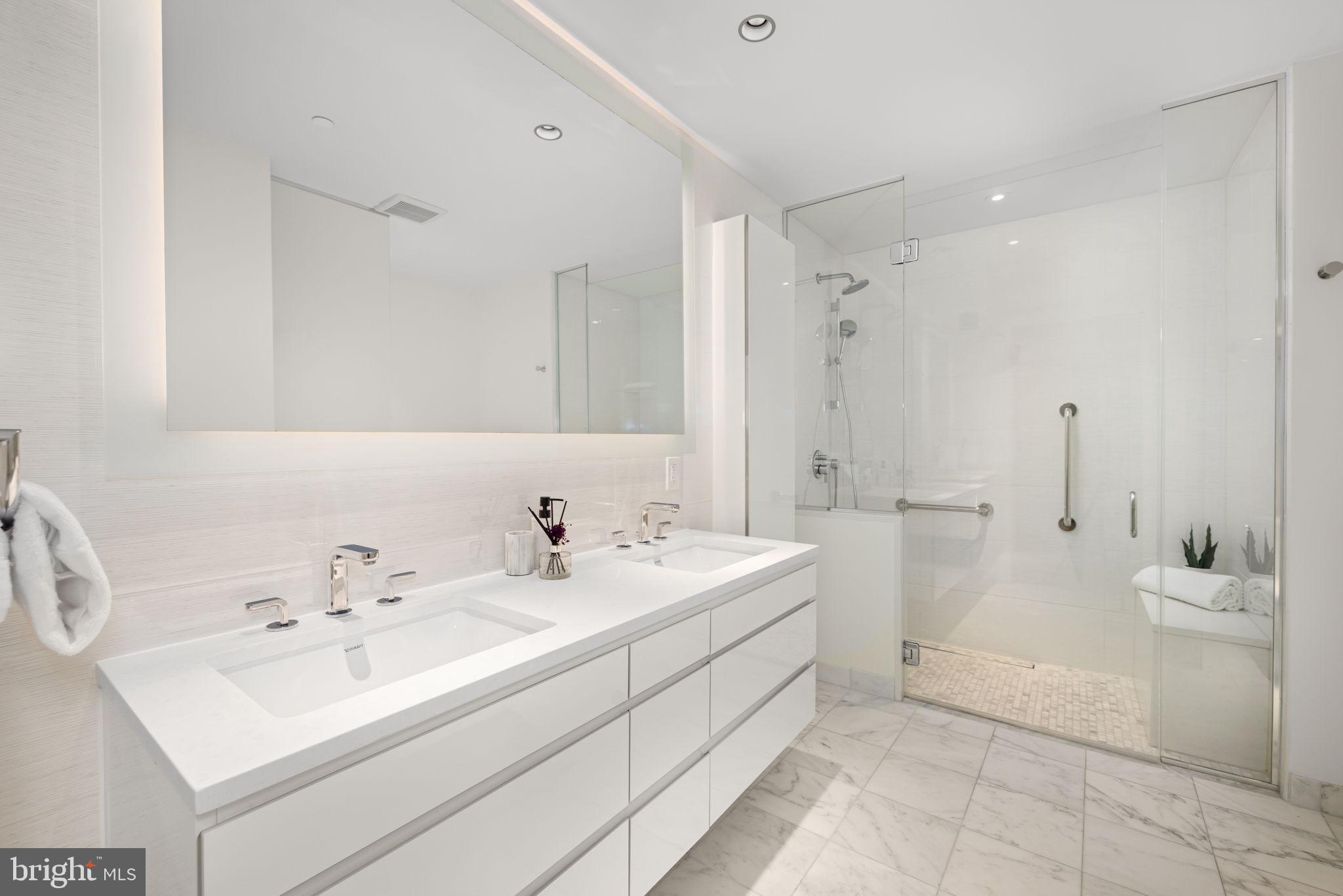 2501 M Street Northwest, Unit T04 Washington, DC 20037 - Photo 12 of 29 a view of bathroom with a sink mirror and a bathtub