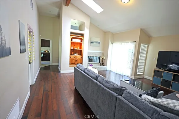 a view of a hallway with wooden floor and closet