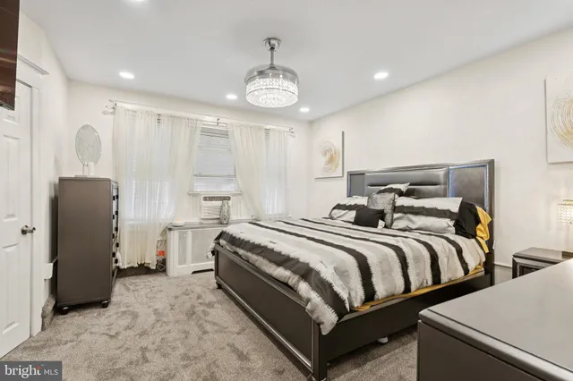 a spacious bedroom with two beds and painted walls