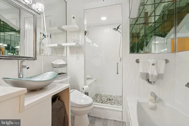 a bathroom with a sink toilet and shower