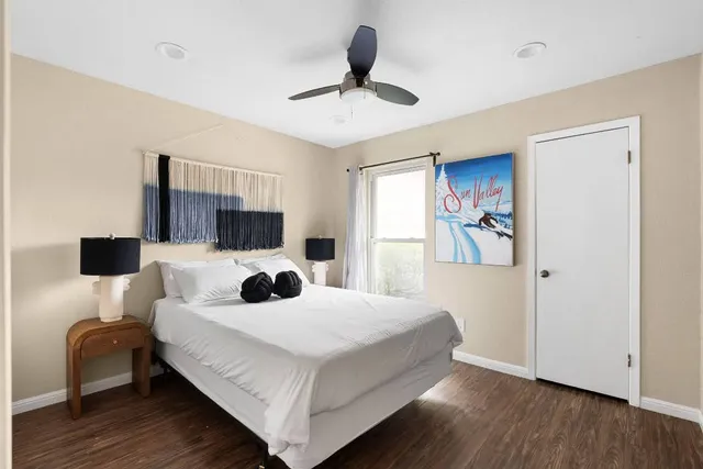 a bedroom with a bed and a flat screen tv