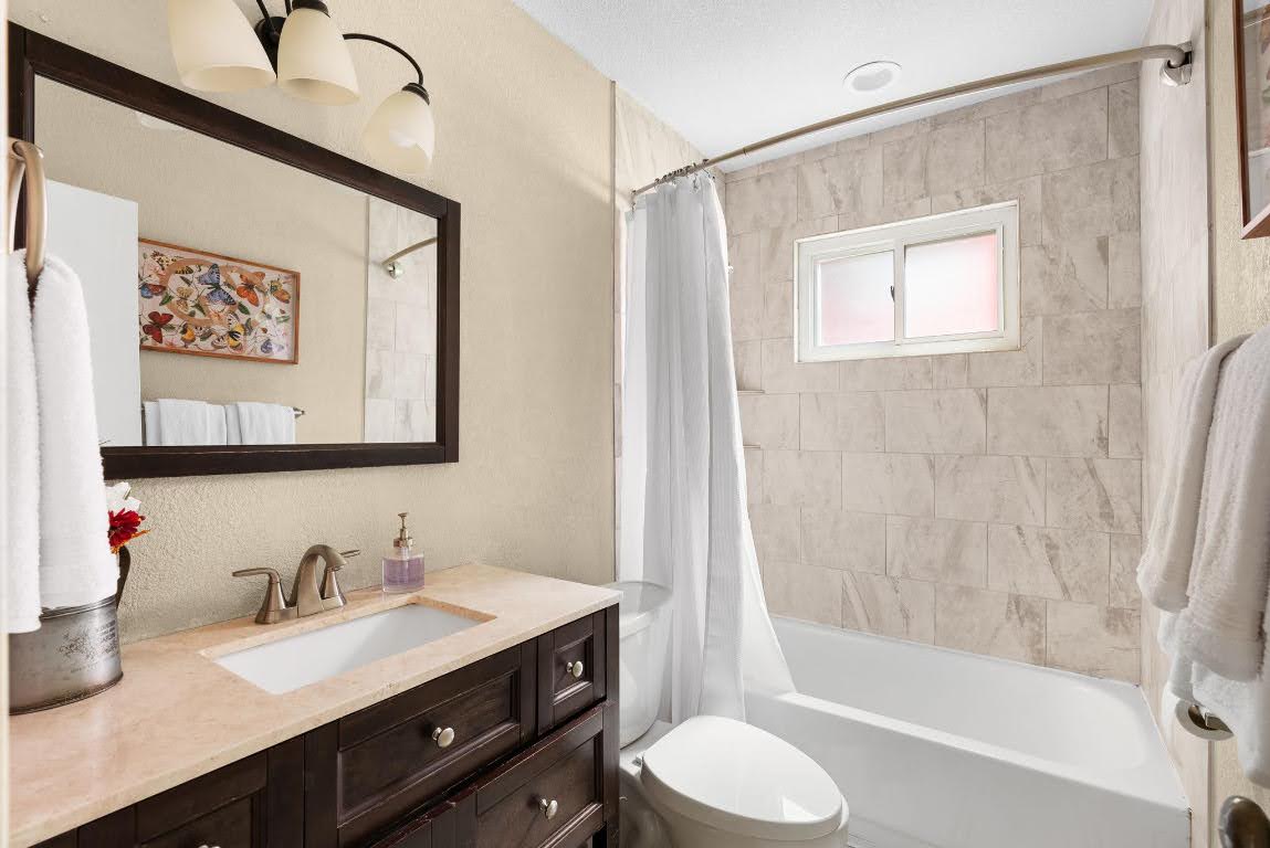 2320 Montclaire Street, Unit A Austin, TX 78704 - Photo 14 of 36 a bathroom with a granite countertop sink toilet and shower