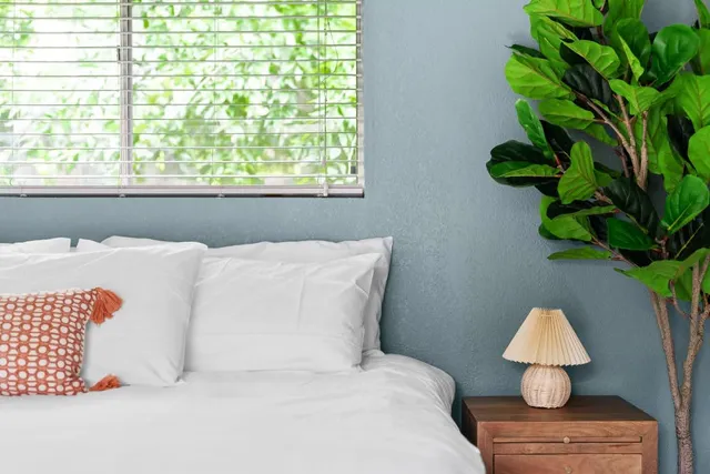 a bed room with a bed and a window