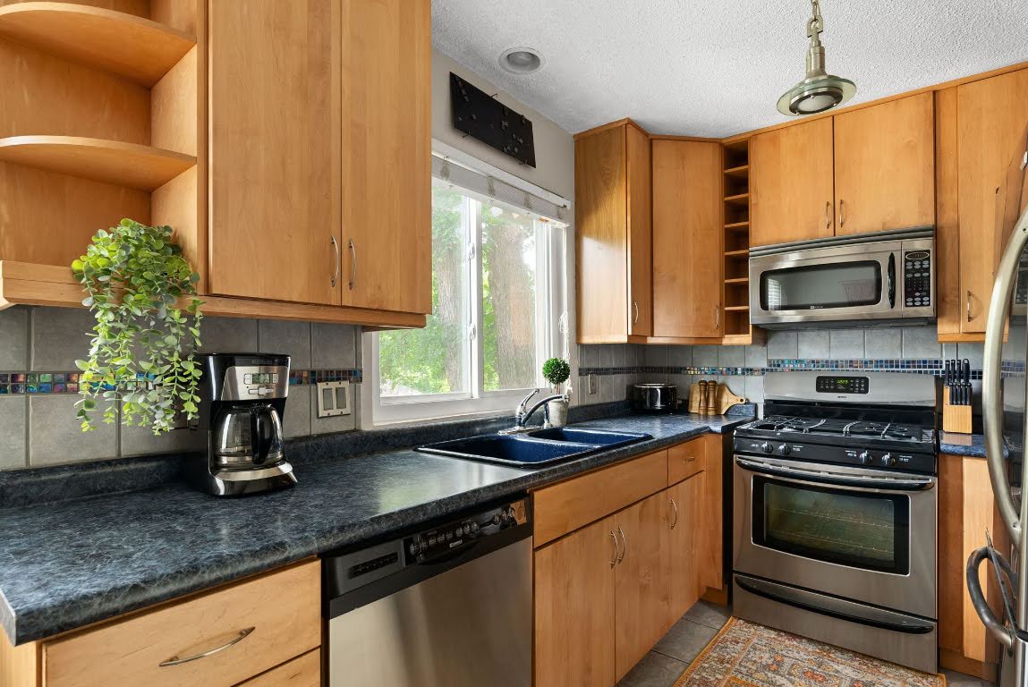 2320 Montclaire Street, Unit A Austin, TX 78704 - Photo 24 of 36 a kitchen with stainless steel appliances granite countertop a sink a stove cabinets counter space and a window