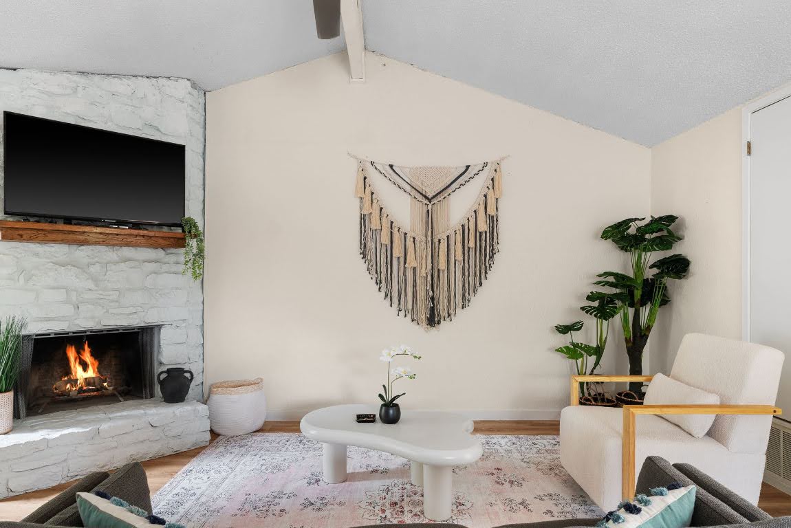 2320 Montclaire Street, Unit A Austin, TX 78704 - Photo 31 of 36 a living room with furniture a flat screen tv and a fireplace