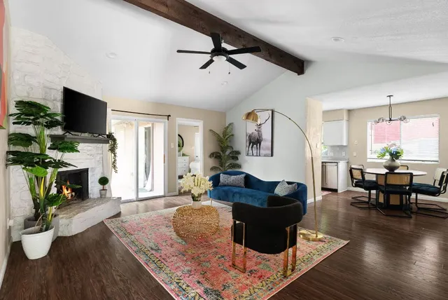 a living room with furniture a fireplace and a flat screen tv