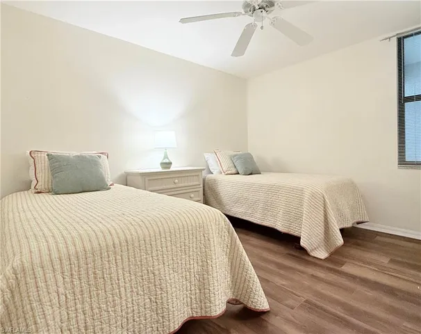 a bedroom with a bed and a ceiling fan
