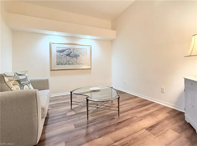 a view of a livingroom with wooden floor and chair